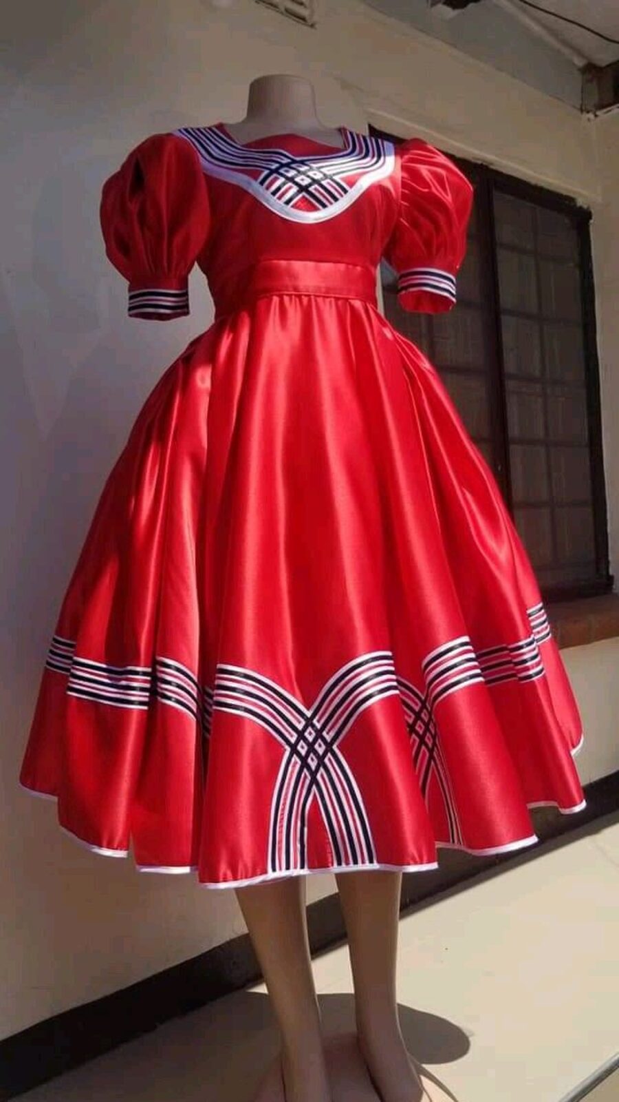 Misisi attire in red and white